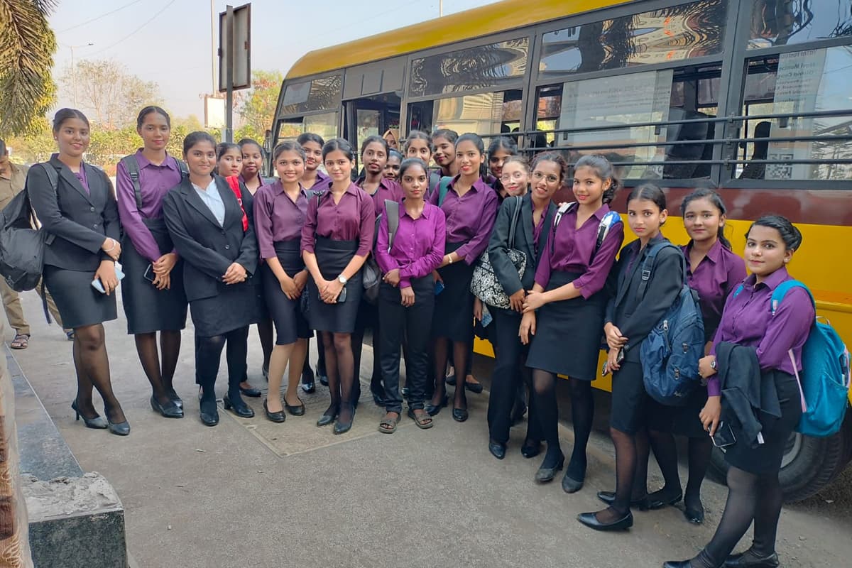 A Centuria batch in uniform in front of a bus during an industry visit
