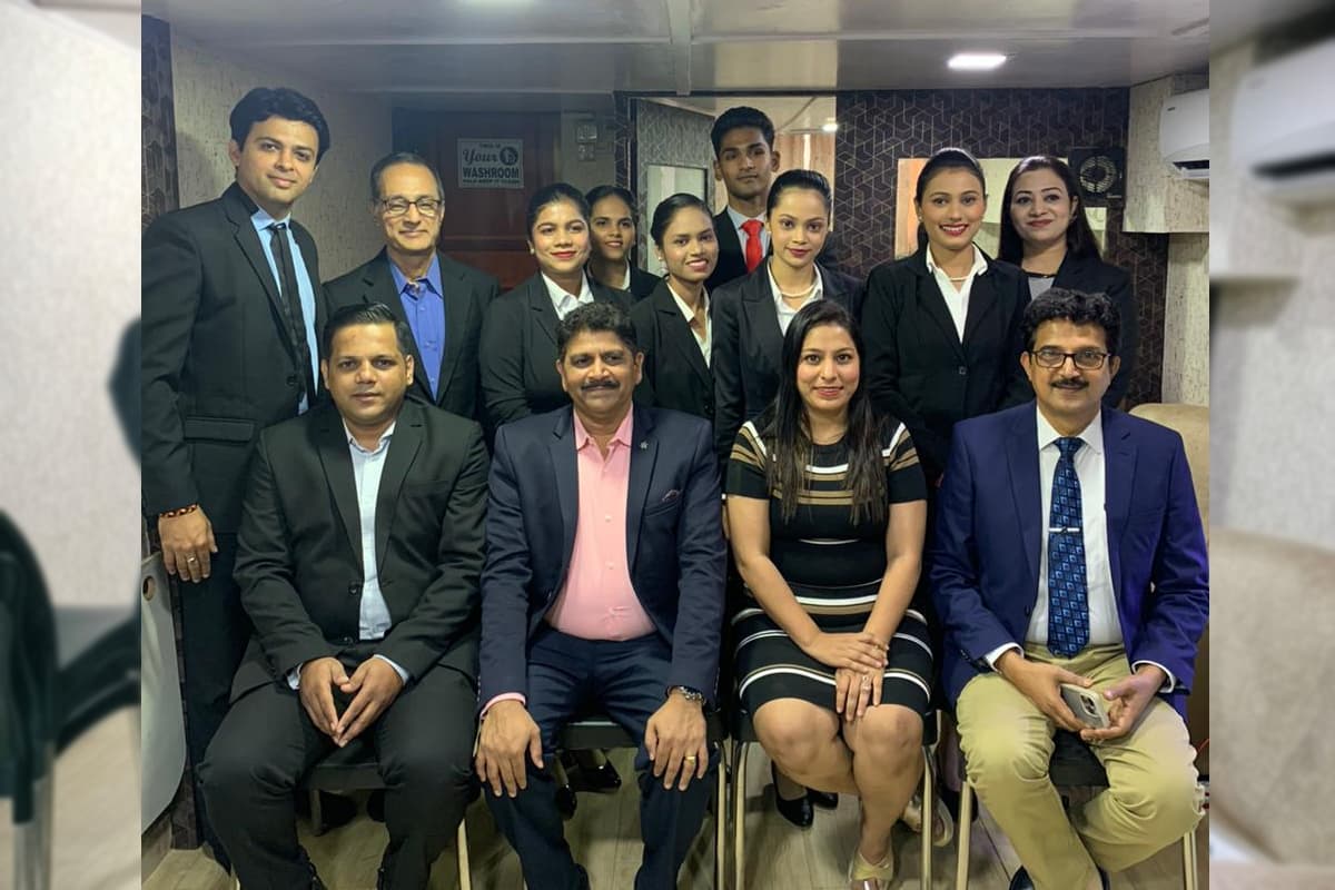 A Centuria batch standing behind faculty members seated in front