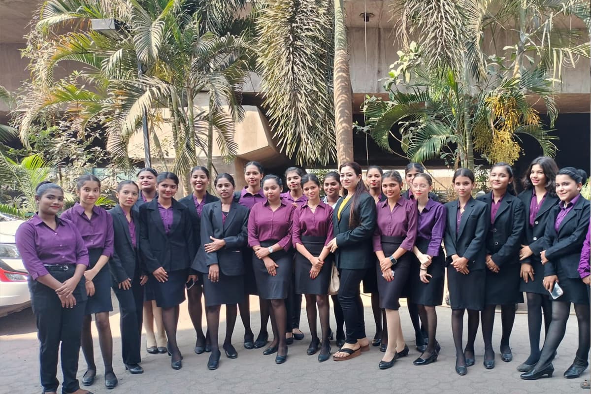 A full Centuria batch in purple shirts and black blazers standing outdoors